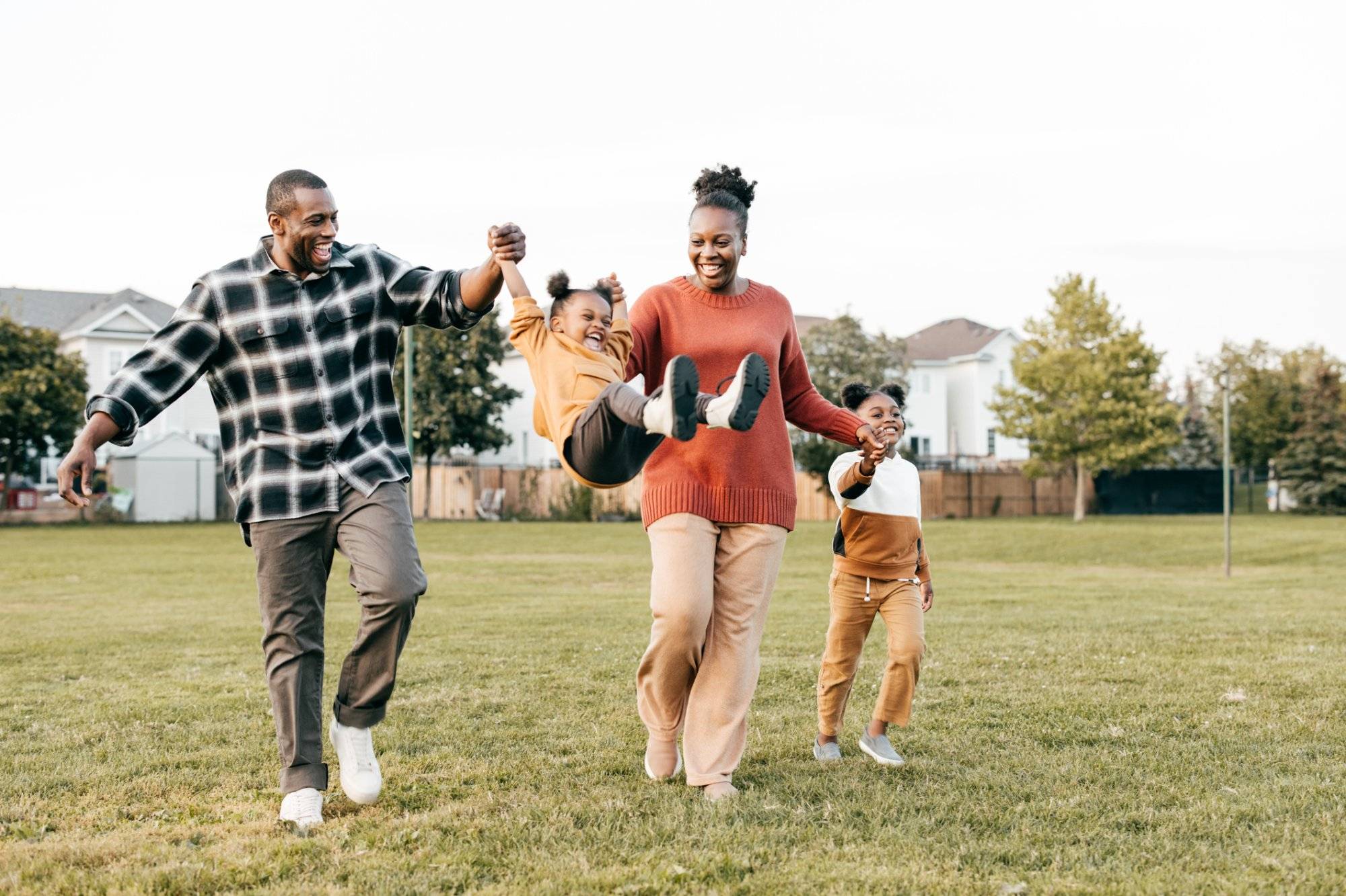 Family enjoying springtime outdoors with kids Family first : parents enjoying springtime outdoors with kids