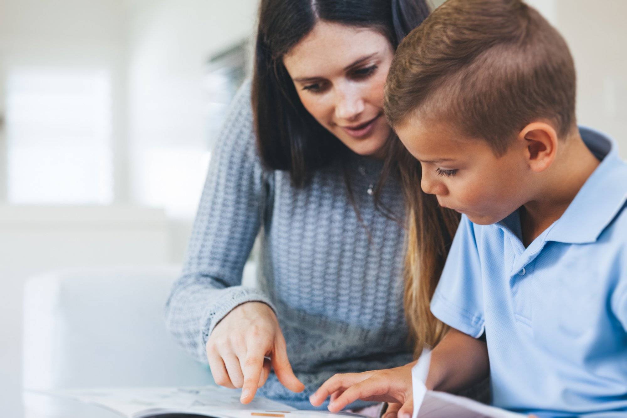boy getting tutored with school assignment boy getting tutored with school assignment