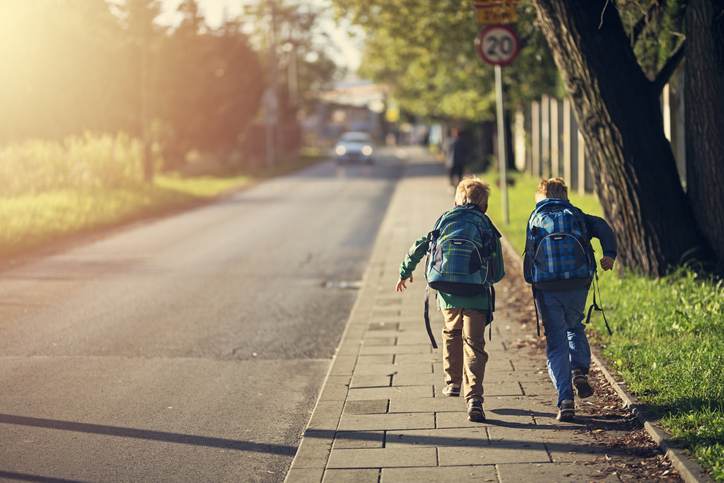 School boys running to school